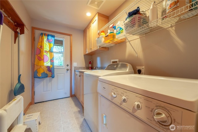 clothes washing area featuring visible vents, separate washer and dryer, and cabinet space