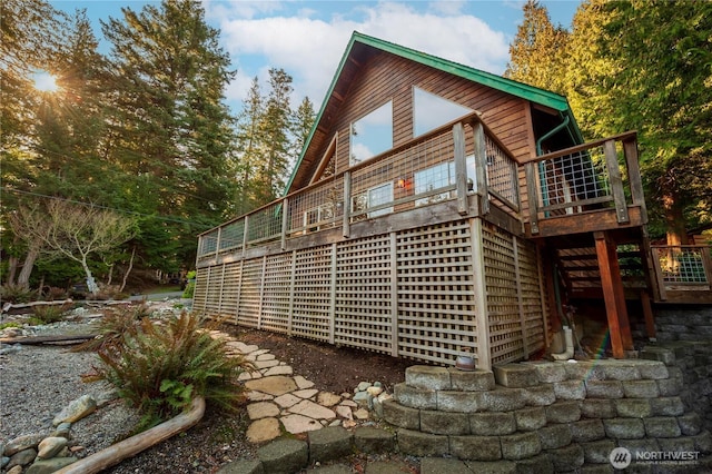 view of side of property featuring stairs and a deck