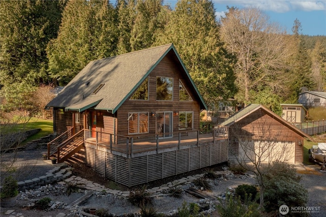 view of front of house featuring a garage and a forest view