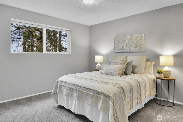 bedroom featuring baseboards, dark colored carpet, and a textured ceiling