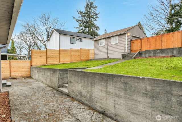 view of property exterior with a fenced backyard and a lawn