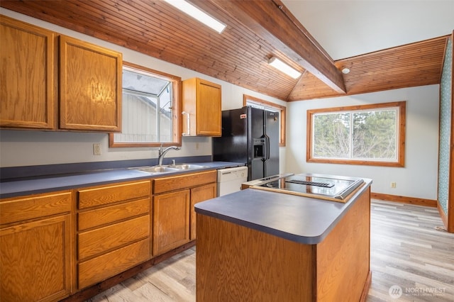 kitchen with wooden ceiling, light wood-style flooring, a sink, a center island, and black appliances