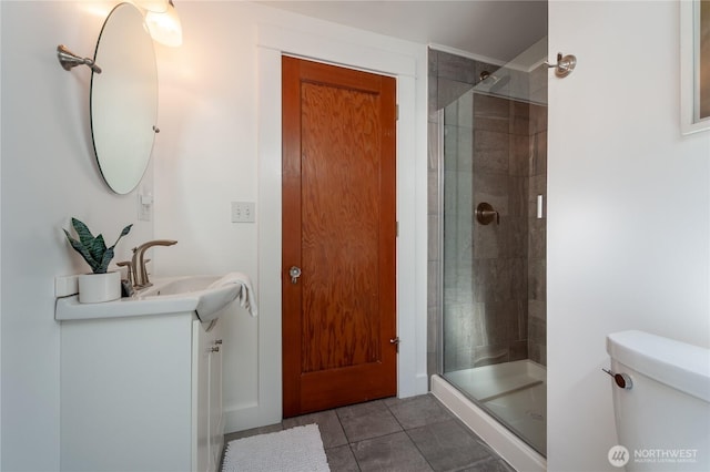 bathroom featuring a stall shower, tile patterned flooring, vanity, and toilet