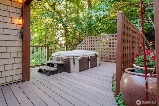 wooden deck with a hot tub