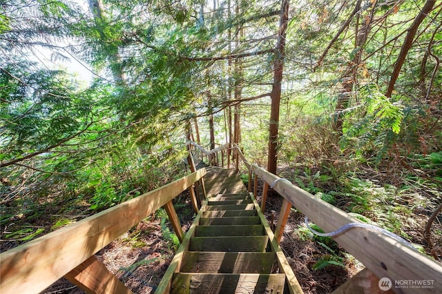 surrounding community featuring a wooded view