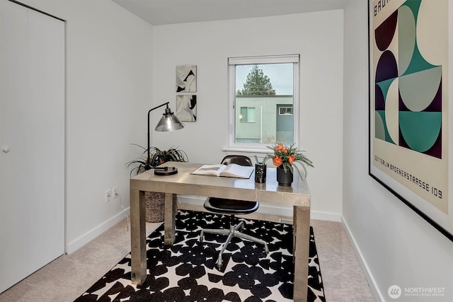 home office with light carpet and baseboards