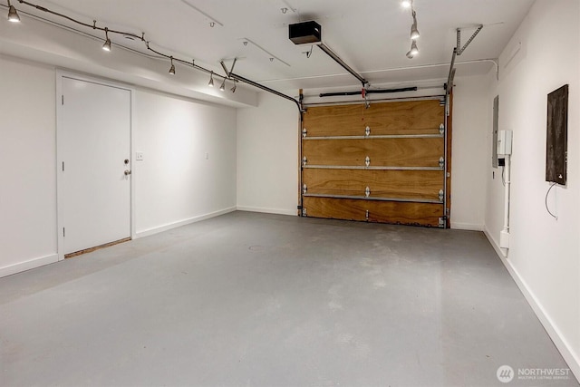 garage with a garage door opener and baseboards