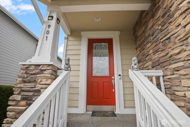 property entrance with stone siding