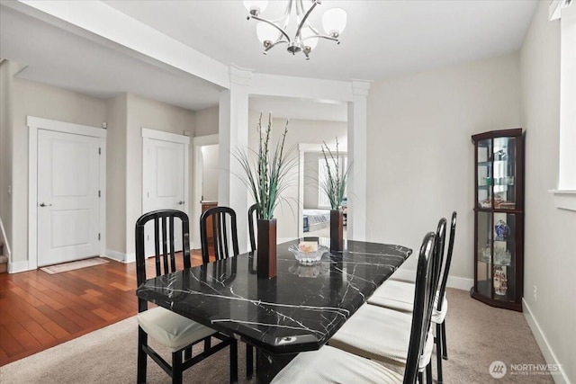 dining area with a notable chandelier, wood finished floors, and baseboards