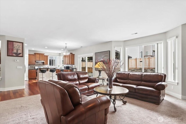 living area with visible vents, recessed lighting, and baseboards