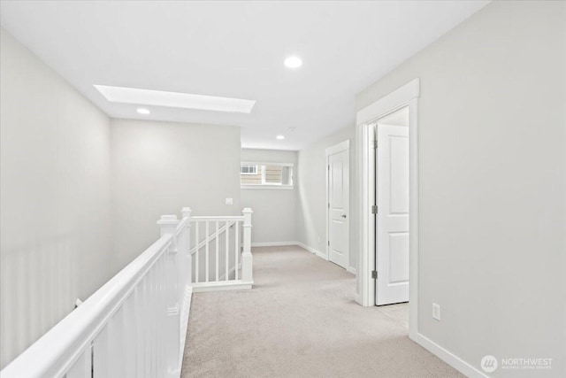 hall featuring recessed lighting, baseboards, an upstairs landing, and light colored carpet