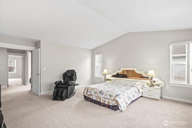 bedroom featuring baseboards, lofted ceiling, and carpet floors