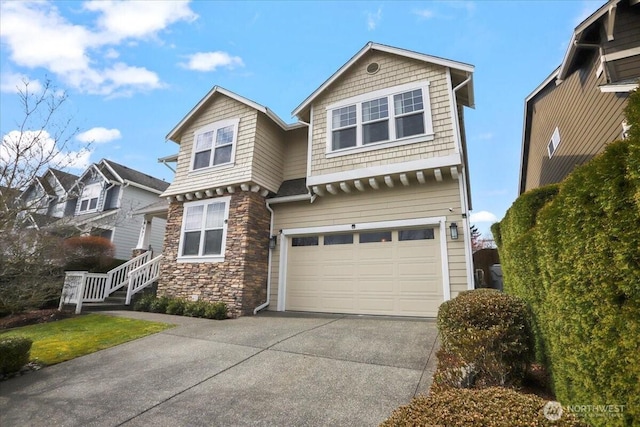 view of front of property with stone siding, a garage, and driveway