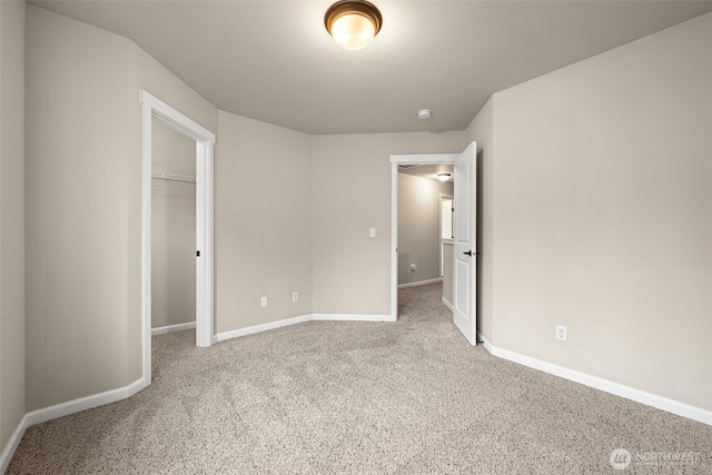 unfurnished bedroom with carpet, a closet, and baseboards