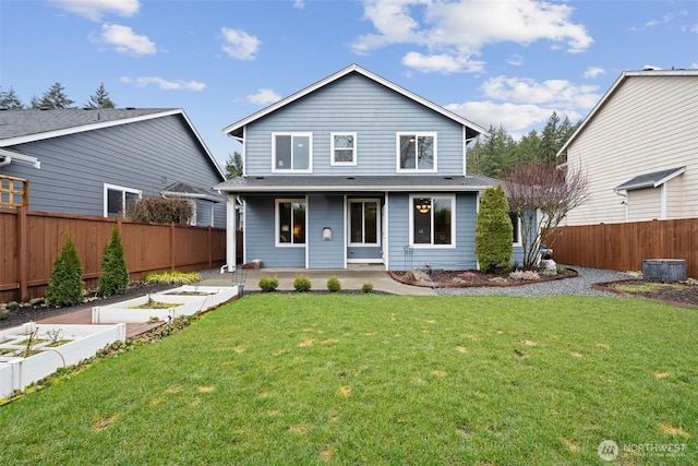 traditional-style house with a front lawn, fence, and a garden