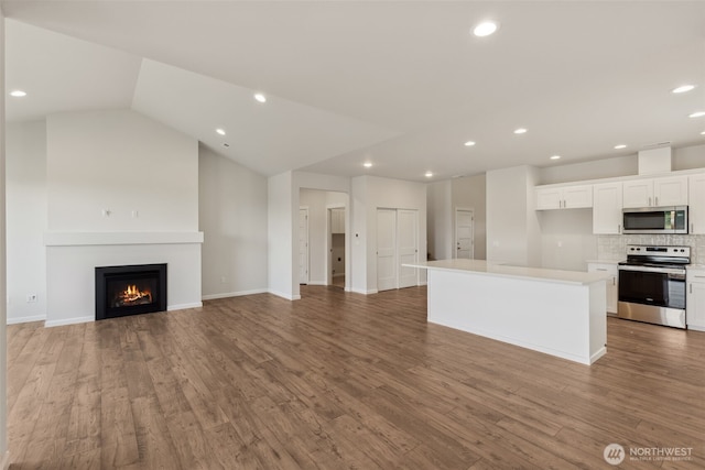 kitchen with a center island, light countertops, appliances with stainless steel finishes, open floor plan, and white cabinets