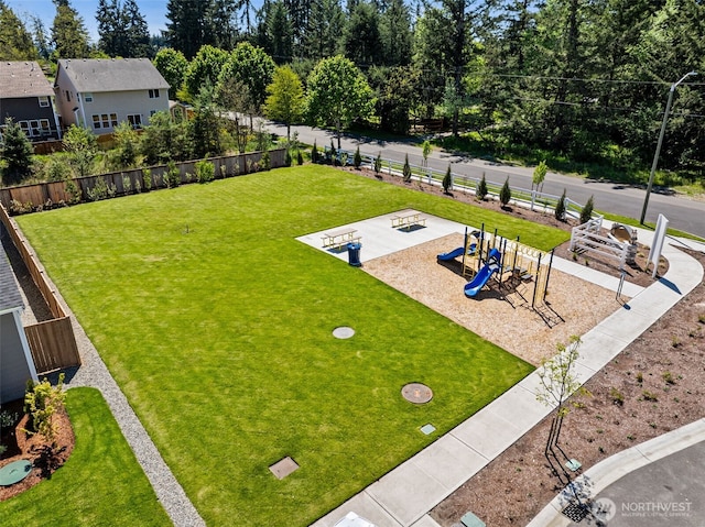 view of yard featuring playground community and fence