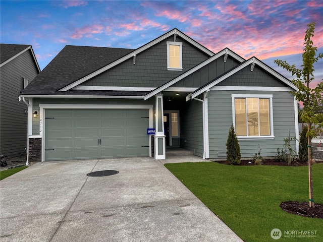 14732 88th Way SE Unit 6, Yelm, WA 98597 - view of front of house with driveway, a yard, an attached garage, a shingled roof, and board and batten siding