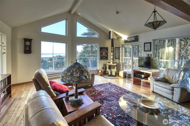 16 Koala Ln, Pacific Beach, WA 98571 - living room with beam ceiling, a wood stove, wood finished floors, and high vaulted ceiling