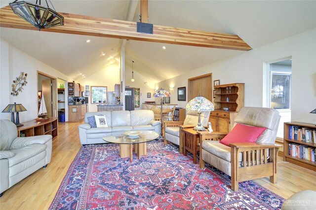 16 Koala Ln, Pacific Beach, WA 98571 - living area featuring beamed ceiling, light wood-type flooring, and high vaulted ceiling