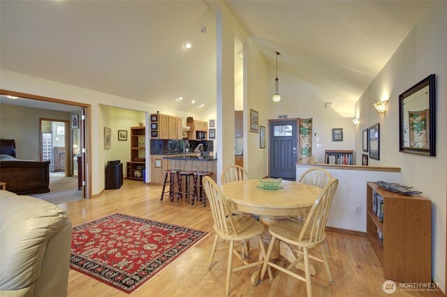 16 Koala Ln, Pacific Beach, WA 98571 - dining space featuring light wood-style floors, high vaulted ceiling, and baseboards