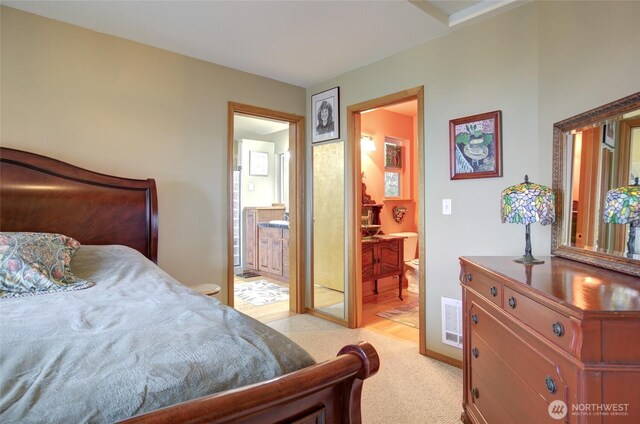 16 Koala Ln, Pacific Beach, WA 98571 - bedroom with ensuite bathroom and light carpet