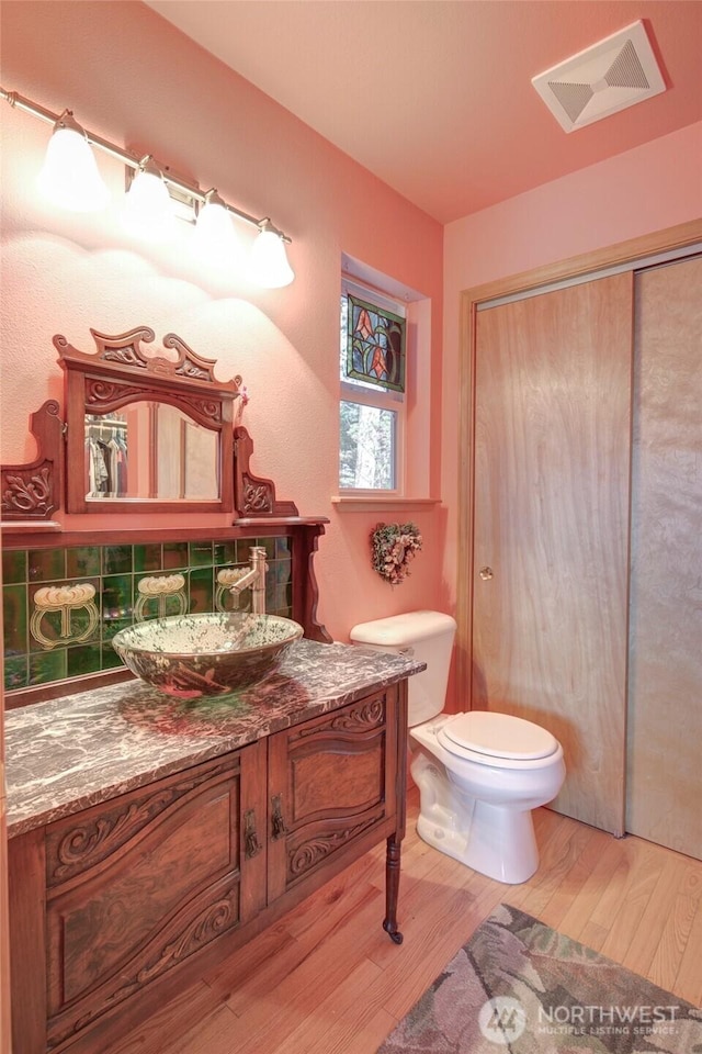 16 Koala Ln, Pacific Beach, WA 98571 - bathroom with wood finished floors, toilet, and vanity