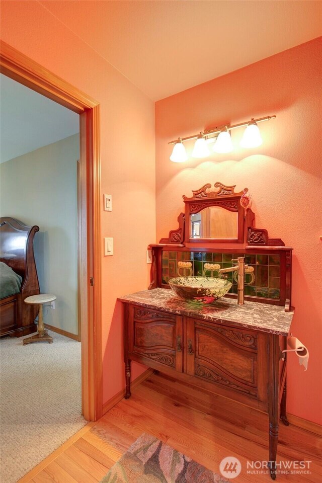 16 Koala Ln, Pacific Beach, WA 98571 - bathroom featuring wood finished floors, vanity, and baseboards