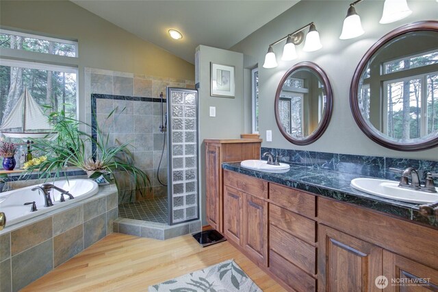 16 Koala Ln, Pacific Beach, WA 98571 - full bathroom with vaulted ceiling, a bath, walk in shower, wood finished floors, and double vanity