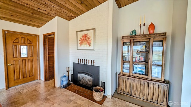 living area with lofted ceiling, wooden ceiling, and a fireplace with flush hearth