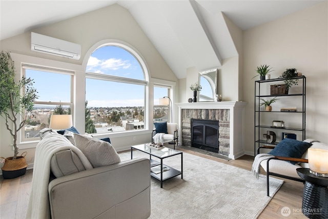 living area featuring high vaulted ceiling, baseboards, light wood-type flooring, a brick fireplace, and a wall mounted air conditioner