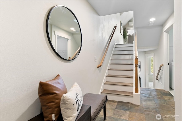 stairs with recessed lighting and stone finish floor