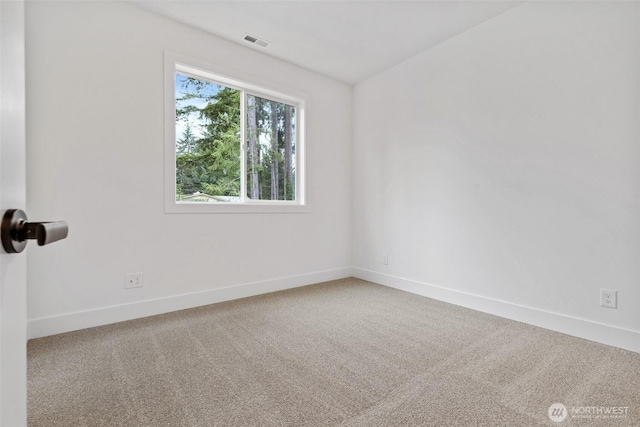 unfurnished room featuring baseboards, visible vents, and carpet flooring