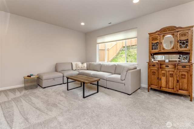 living area featuring recessed lighting, baseboards, and light colored carpet