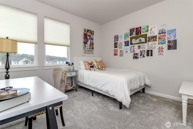 bedroom with baseboards and carpet flooring