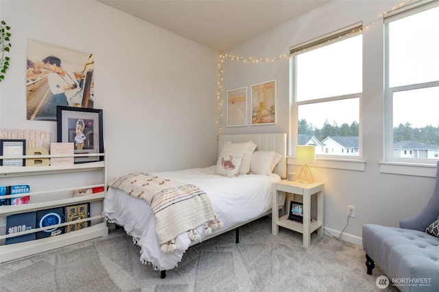 bedroom featuring carpet, multiple windows, and baseboards