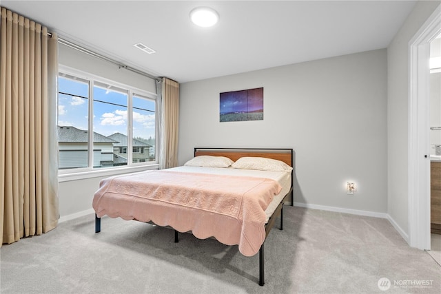 bedroom with baseboards, visible vents, and light colored carpet