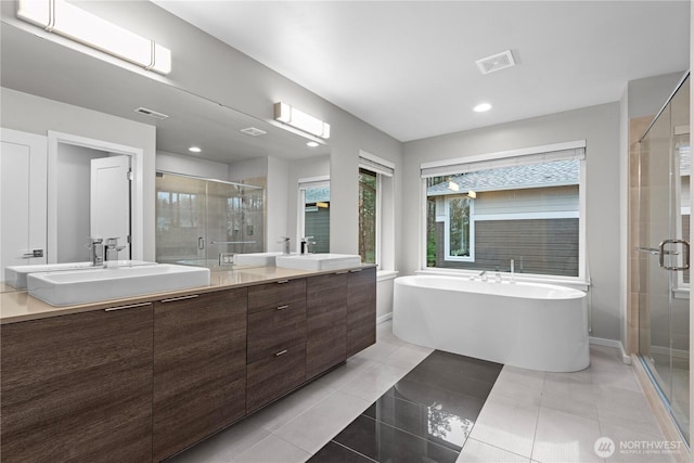 full bath with a stall shower, visible vents, a sink, and tile patterned floors