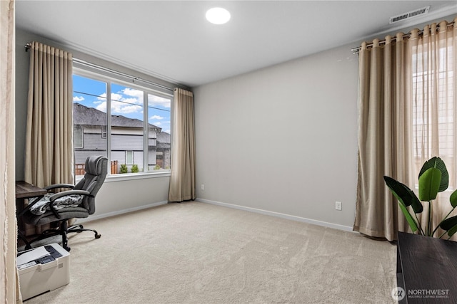 office featuring carpet flooring, visible vents, and baseboards