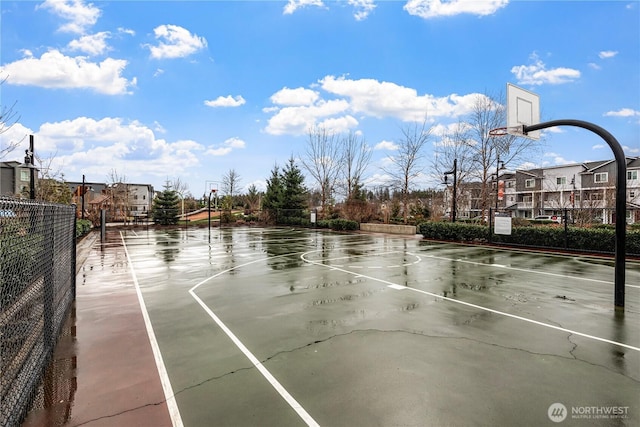 view of basketball court featuring community basketball court and fence