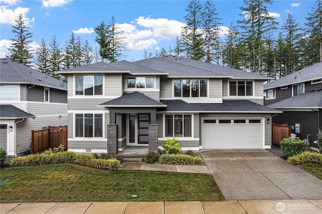 prairie-style house with a shingled roof, concrete driveway, an attached garage, crawl space, and fence