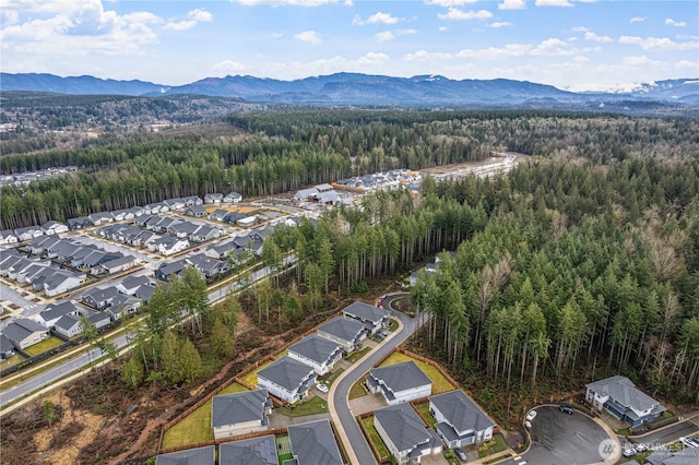 birds eye view of property featuring a residential view, a mountain view, and a forest view