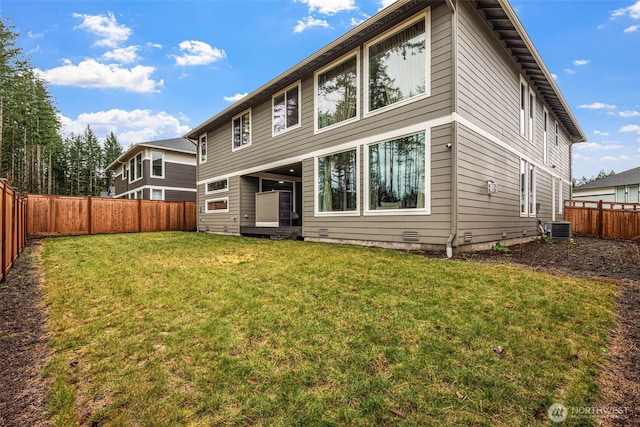 back of house with crawl space, a fenced backyard, a lawn, and central AC unit