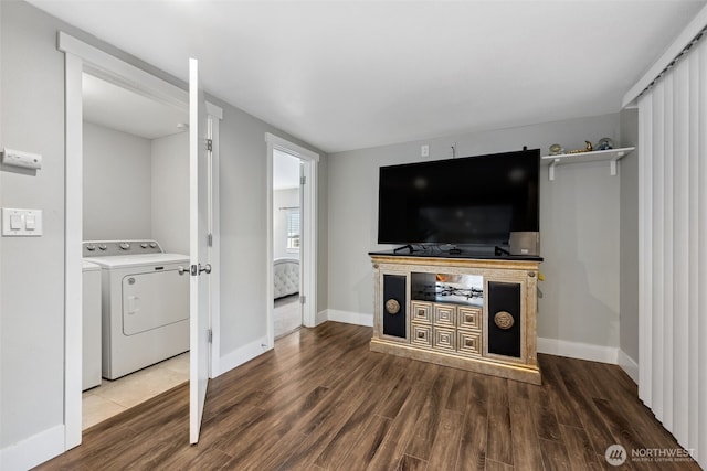 living room with washer / dryer, baseboards, and wood finished floors