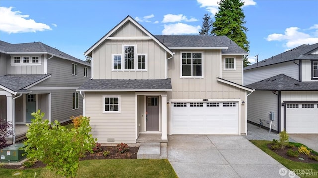 view of front of home featuring driveway, a garage, board and batten siding, and roof with shingles