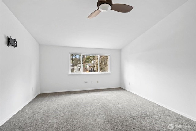 carpeted empty room featuring a ceiling fan and baseboards