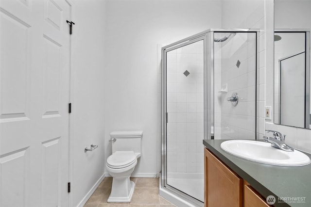 full bathroom with toilet, a stall shower, vanity, baseboards, and tile patterned floors