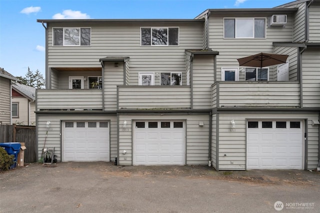 exterior space with an AC wall unit and driveway