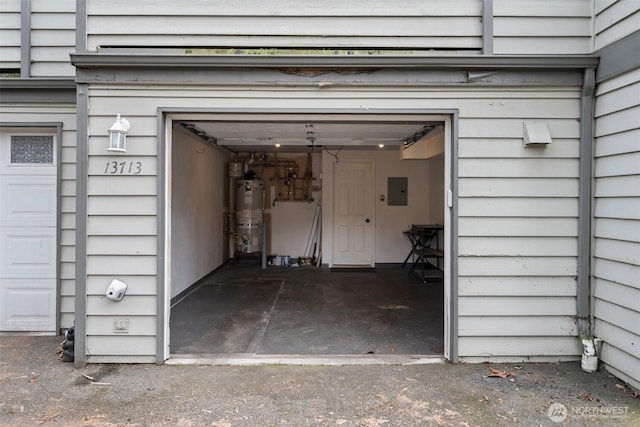 garage featuring water heater and electric panel