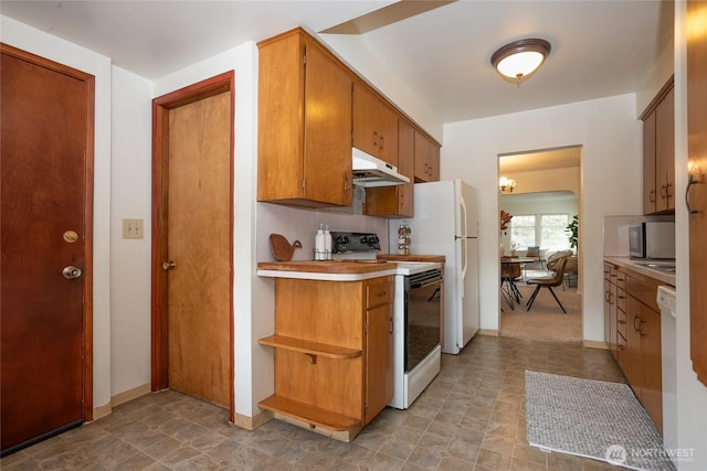 kitchen featuring under cabinet range hood, white appliances, light countertops, open shelves, and brown cabinetry